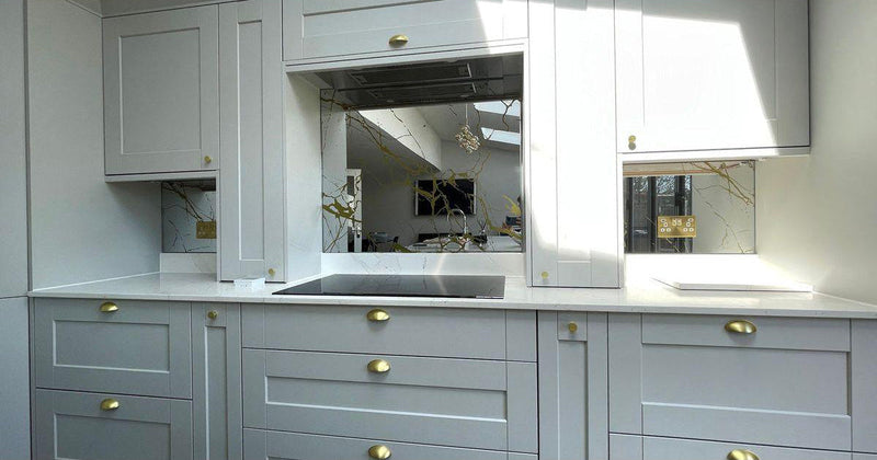 Bespoke decorative glass mirror with etched branch design in modern kitchen, featuring luxury residential glass solutions.