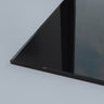 Sleek black glass panel corner, showcasing precision edge detailing for modern architectural installations