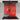 Vibrant red and gold swirl decorative glass splashback in modern kitchen with induction hob