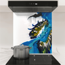 Modern kitchen stovetop with stainless steel pot and colorful blue, yellow, black, and white abstract backsplash