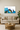 Modern living room with beige sofa, wooden coffee table, abstract blue and green wall art