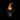 Black French bulldog wearing orange and black striped witch hat on dark background