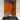 Modern kitchen stovetop with stainless steel pot and orange backsplash with black and white abstract design