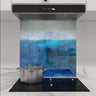 Bespoke blue abstract glass kitchen splashback with modern cooktop and hood