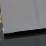 Close-up of sleek, polished glass edge with black accent, ideal for modern balustrades or decorative panels.
