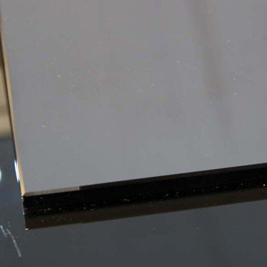 Close-up of sleek, polished glass edge with black accent, ideal for modern balustrades or decorative panels.