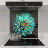 Custom kitchen glass splashback with turquoise floral design, modern cooktop and hood