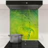 Modern kitchen stovetop with stainless steel pot and colorful green-yellow vortex backsplash