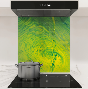 Modern kitchen stovetop with stainless steel pot and colorful green-yellow vortex backsplash