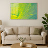 Modern living room with beige sofa, green cushions, round wooden coffee table, and abstract green-yellow vortex wall art