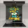 Colorful 'Wake Up & Be Awesome' glass splashback in modern kitchen with induction hob