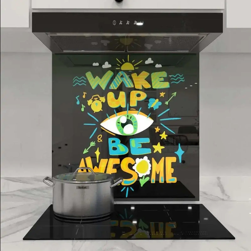 Colorful 'Wake Up & Be Awesome' glass splashback in modern kitchen with induction hob