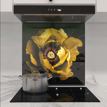 Custom kitchen glass splashback with vibrant yellow flower design, modern induction hob and marble countertop