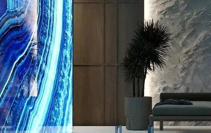 LED backlit glass wall art with blue agate pattern in modern luxury poolside setting