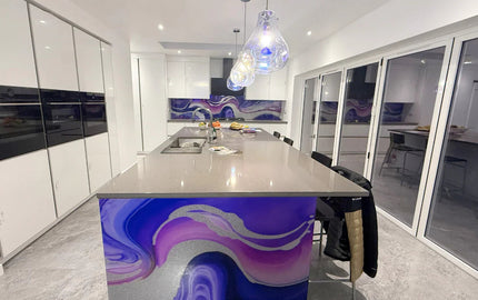 Bespoke kitchen island with purple and silver decorative glass panel, modern luxury interior design