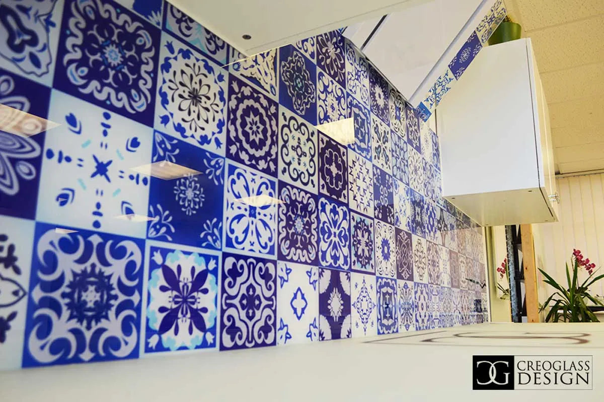 Bespoke decorative glass wall with blue and white patterned tiles for commercial interiors