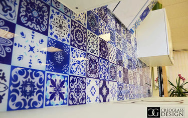 Blue and white patterned glass splashback with ornate tile designs in a modern kitchen