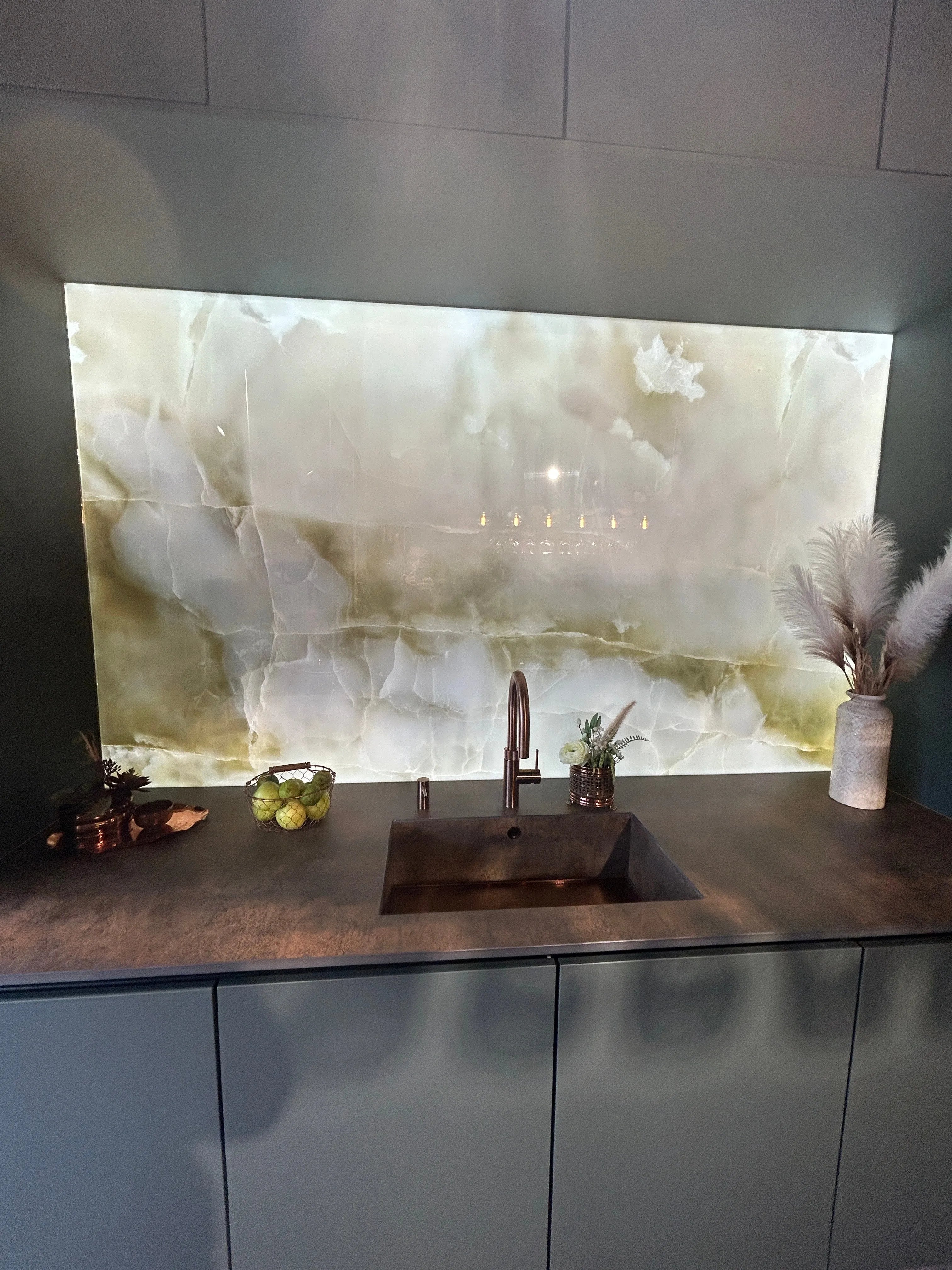 Bespoke glass splashback with marble effect, modern kitchen sink, and stylish decor accents
