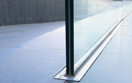 Modern glass balustrade with sleek metal base, ideal for luxury residential or commercial spaces.