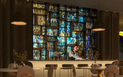 Bespoke glass splashback with vibrant mosaic design in modern bar setting