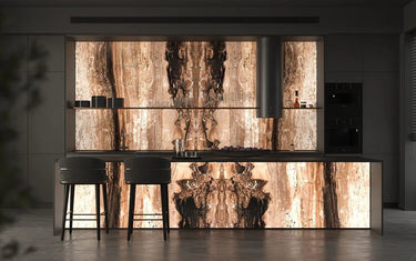 Luxury kitchen with backlit decorative glass feature wall and island, showcasing bespoke architectural glass design.