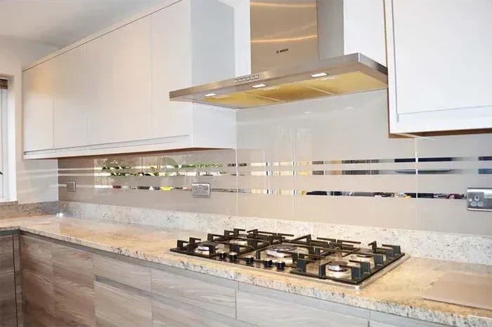 Modern kitchen with sleek glass splashback, granite countertop, and stainless steel hob