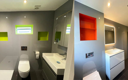 Modern bathroom with vibrant green and orange glass shelves, sleek vanity, and LED-lit mirror