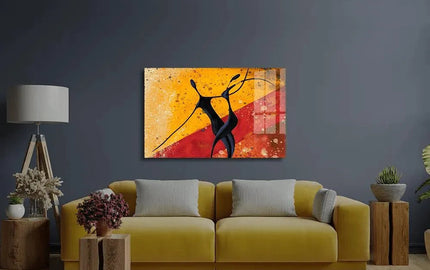 Abstract glass art with black figures on warm yellow-red background, modern living room decor