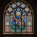 Bespoke stained glass window featuring angel and dragon, intricate decorative glass design for architectural use