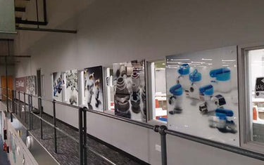 John Guest workplace corridor with bespoke printed glass wall art by CreoGlass