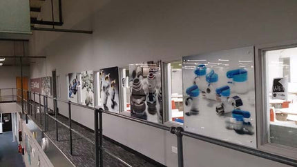 John Guest workplace corridor with bespoke printed glass wall art by CreoGlass