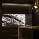 Luxury kitchen with marble-effect glass splashback, modern black cabinets, and under-cabinet lighting