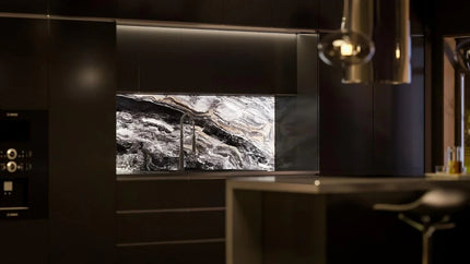 Luxury kitchen with bespoke marble-effect glass splashback and modern fixtures