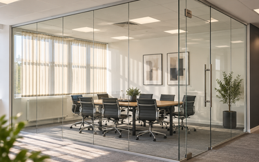 Concept visual of a frameless office glass partition meeting room with full-height clear glazing