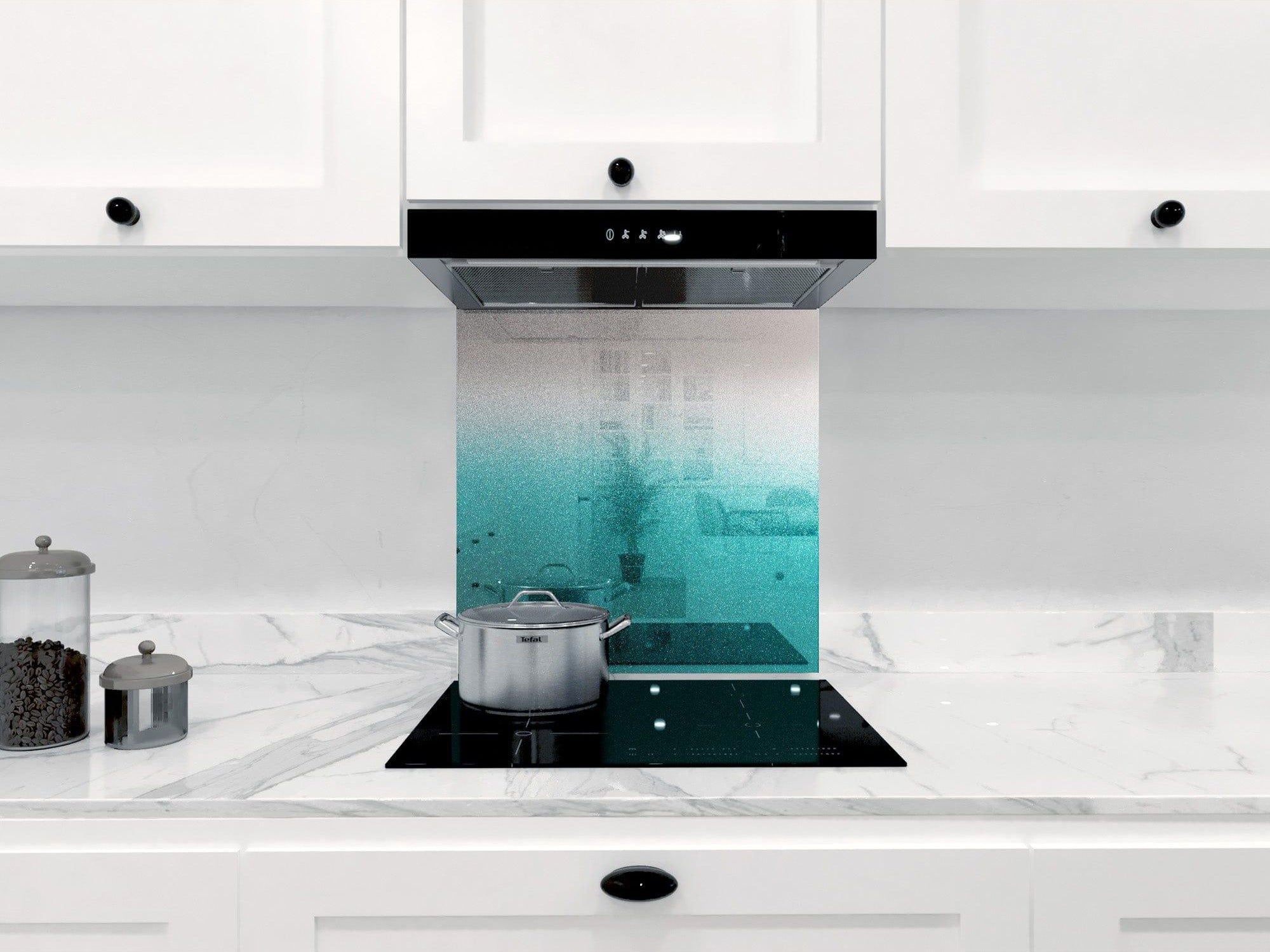 Teal ombre glass splashback in modern white kitchen with marble countertop and induction hob