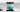 Teal ombre glass kitchen splashback with marble countertop and induction hob