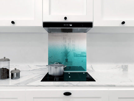 Teal ombre glass kitchen splashback with marble countertop and induction hob