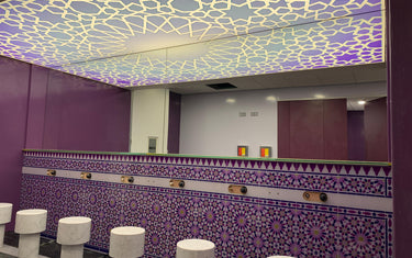 Bespoke decorative glass ceiling with geometric pattern and purple mosaic tile wall in luxury interior