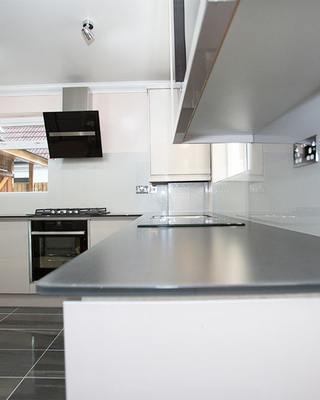 Modern kitchen with sleek glass splashback and premium design features