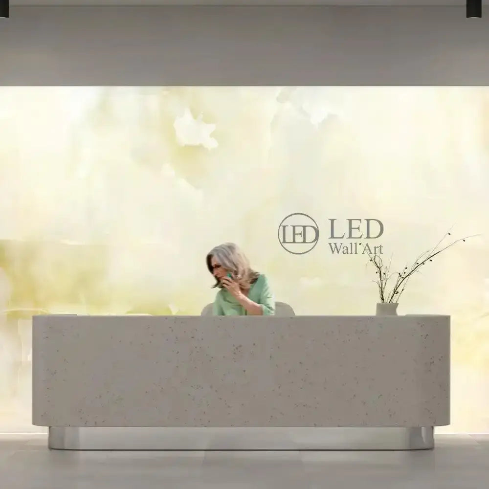 LED backlit glass wall art in modern reception with woman on phone
