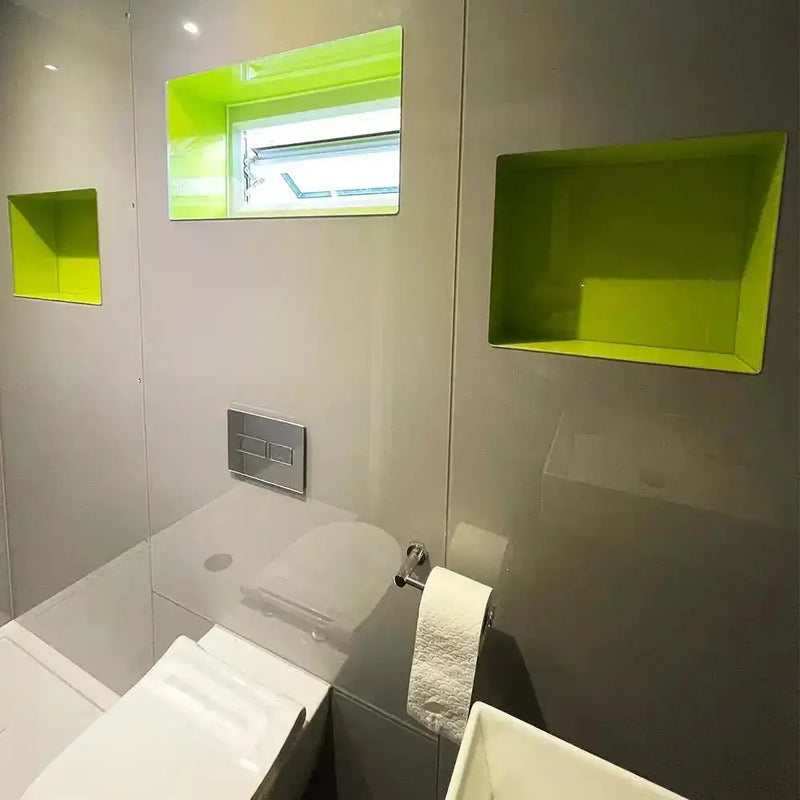 Modern bathroom with lime green recessed glass shelves and sleek white fixtures