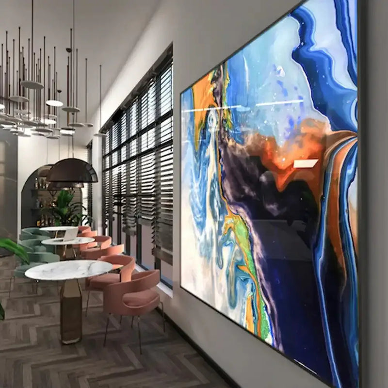 Bespoke decorative glass wall art with abstract blue, orange, and green swirls in modern café setting