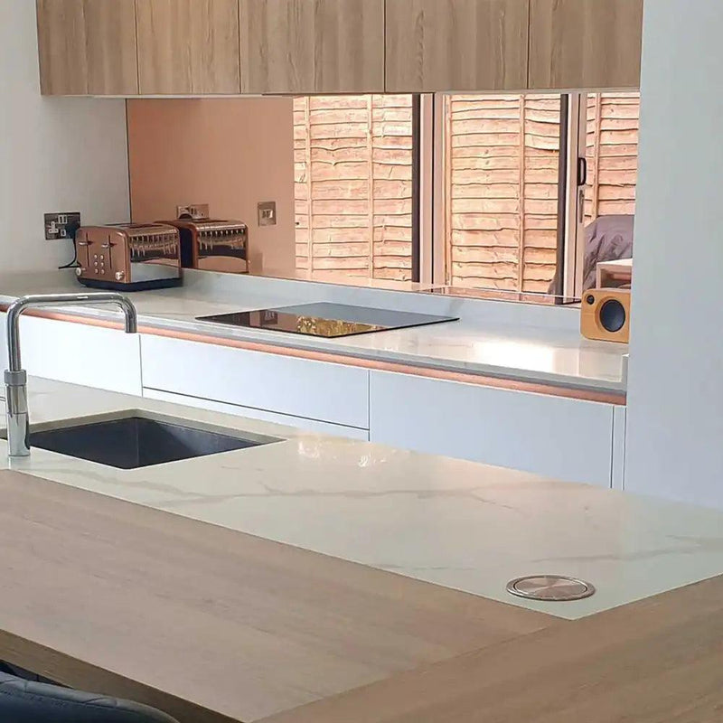 Bespoke kitchen with feature mirror backsplash and LED backlit glass countertop