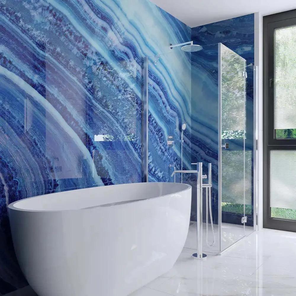 Luxury bathroom with blue marble-patterned decorative glass wall and freestanding tub