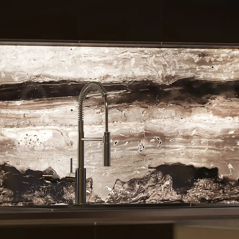 Luxury kitchen with LED backlit decorative glass backsplash featuring marble-like patterns and modern faucet