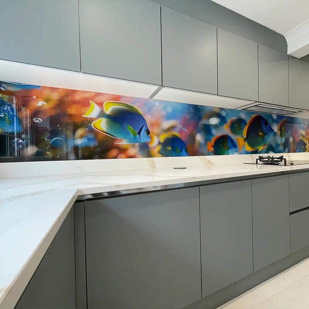 Vibrant fish print decorative glass backsplash in modern kitchen with grey cabinets and white countertop