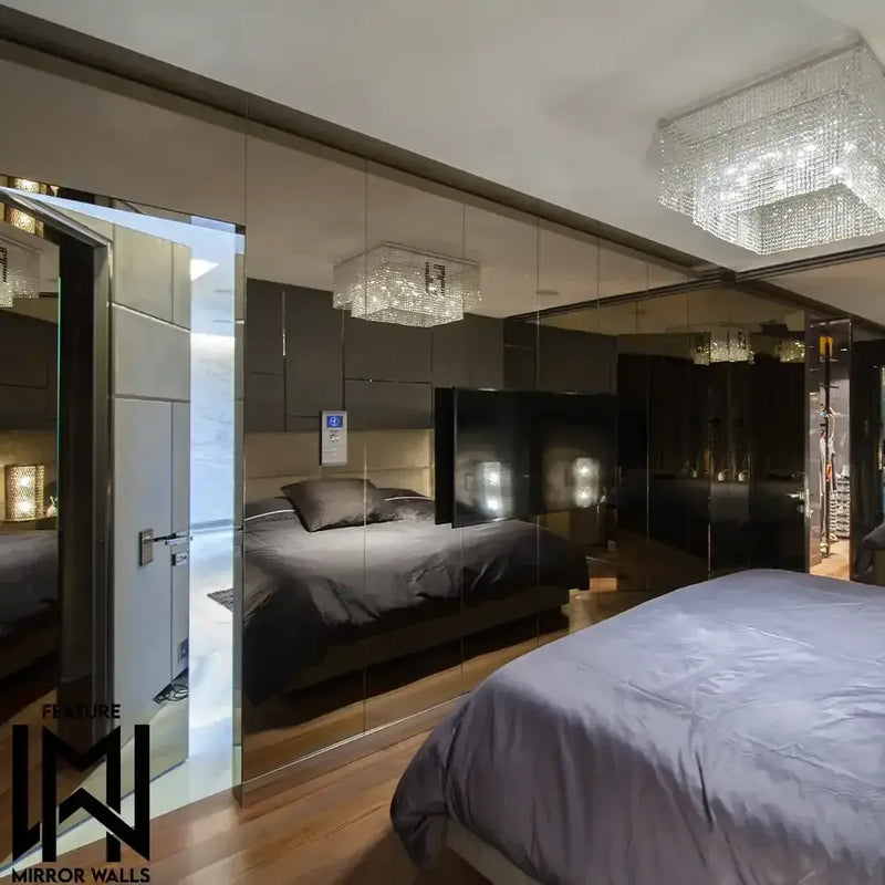 Luxury bedroom with bespoke mirror walls and LED backlit glass features, modern chandelier, dark bedding