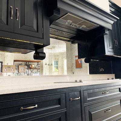 Antique mirror splashback with a distressed reflective finish in a bespoke kitchen