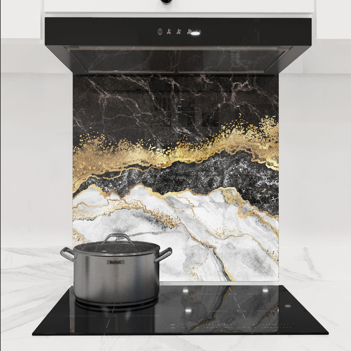 Luxury kitchen splashback with black, white marble and gold foil design, modern cooktop and hood