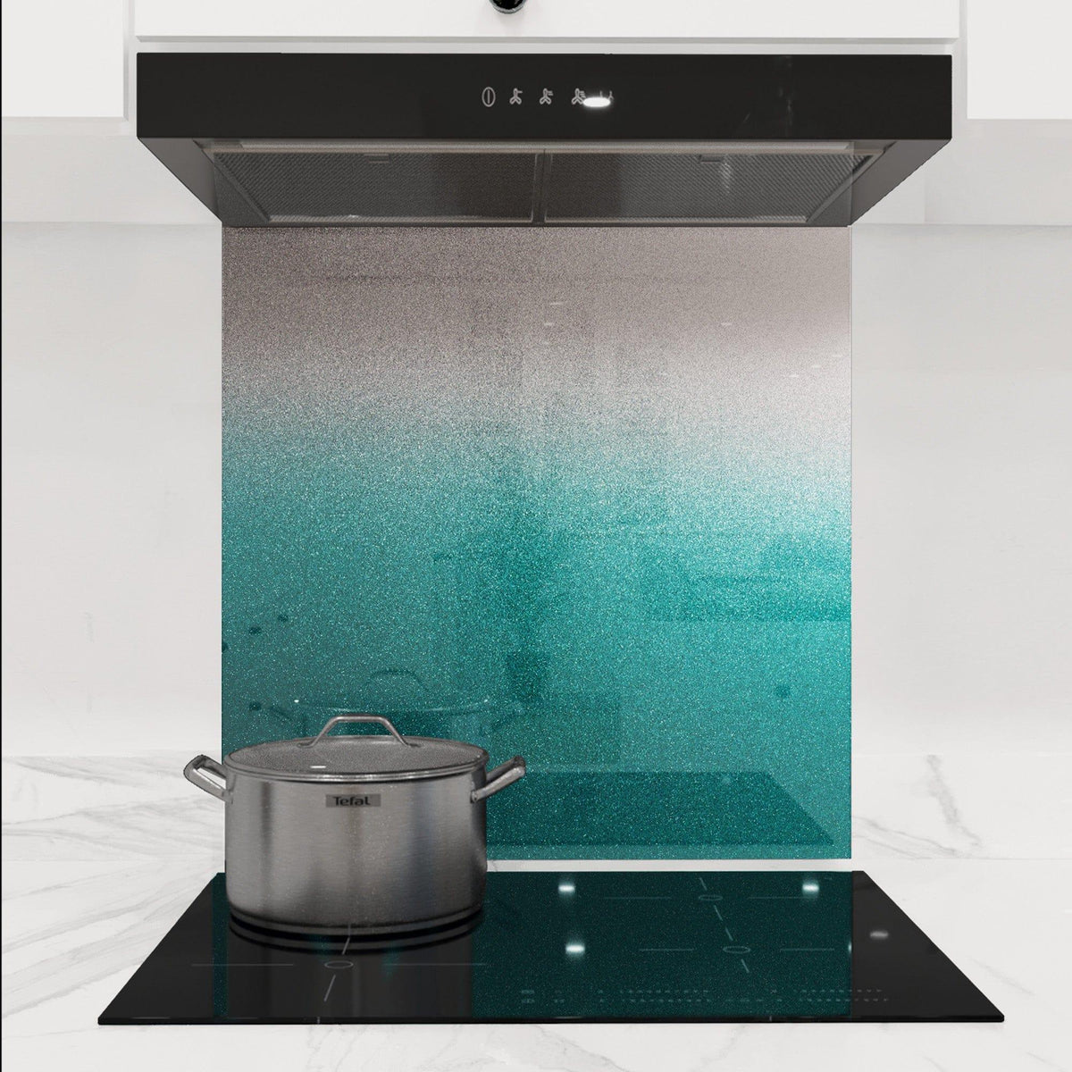 Teal ombre decorative glass splashback in modern kitchen with induction hob and extractor hood